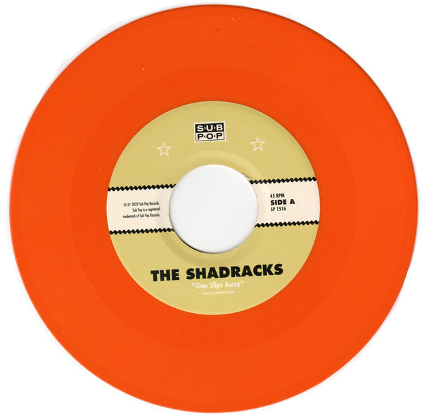 The Shadracks (3) : Time Slips Away b/w Hollow And Uncertain (7", Single, Club, Ltd, Ora)